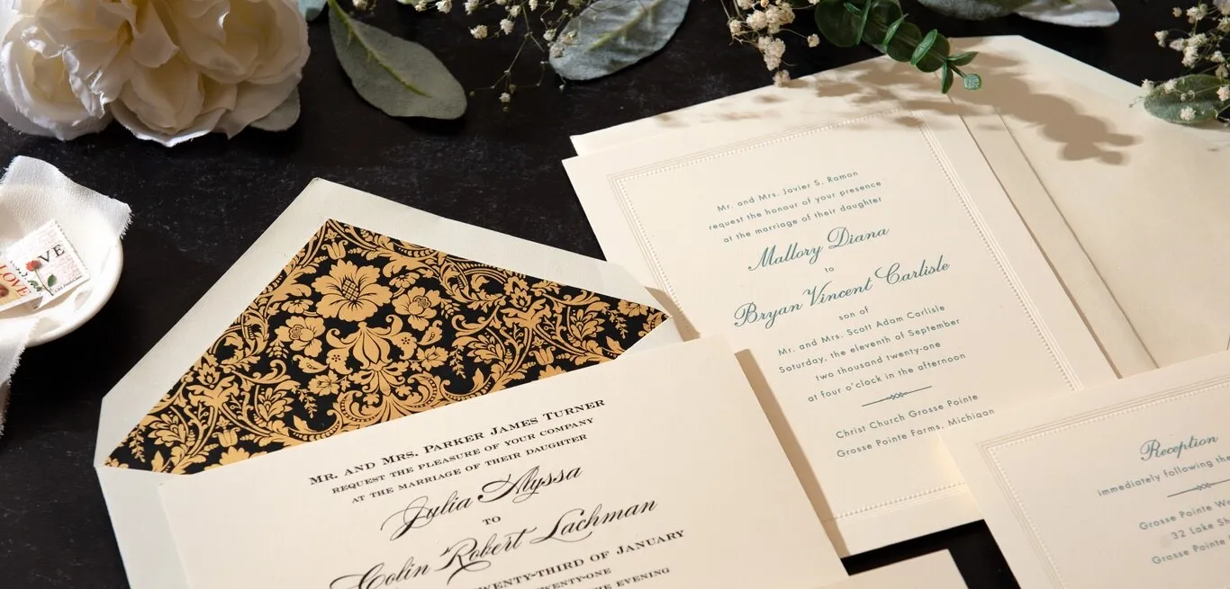 Crane wedding invitation suites with bordered cards, floral envelope lining, and cream envelopes